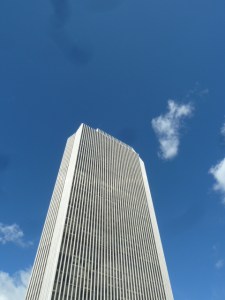 View up from the base of the Corning Tower Building at a mostly cloudless sky
